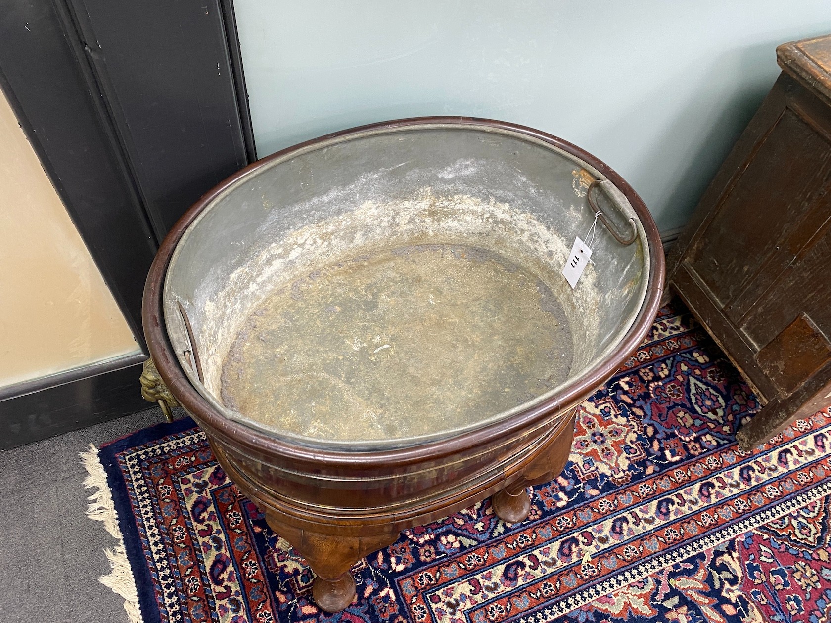 A George III style oval brass bound mahogany wine cooler on stand, width 60cm, depth 44cm, height 66cm